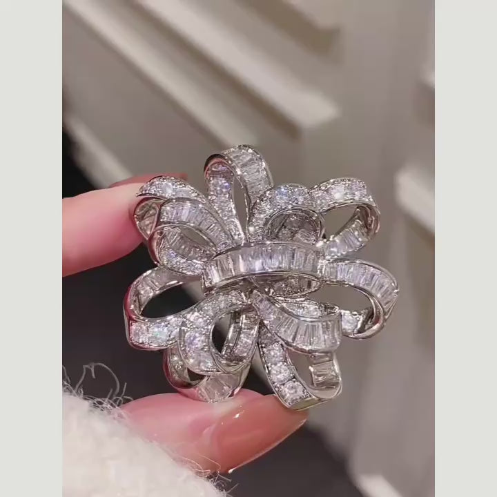 Actual silver-tone Elva crystal ribbon rosette brooch turning in the light; silent film