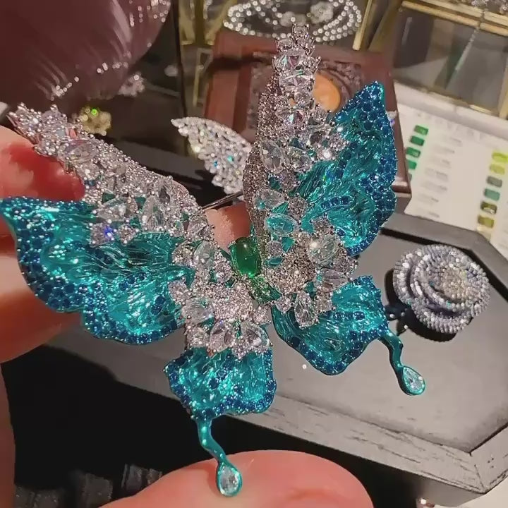 Airi layered blue butterfly brooch in motion; silent 5-second close-up.