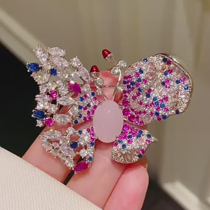 Venla Contrast-Wing Zircon Butterfly Brooch in a silent product film. Pink finish shown.