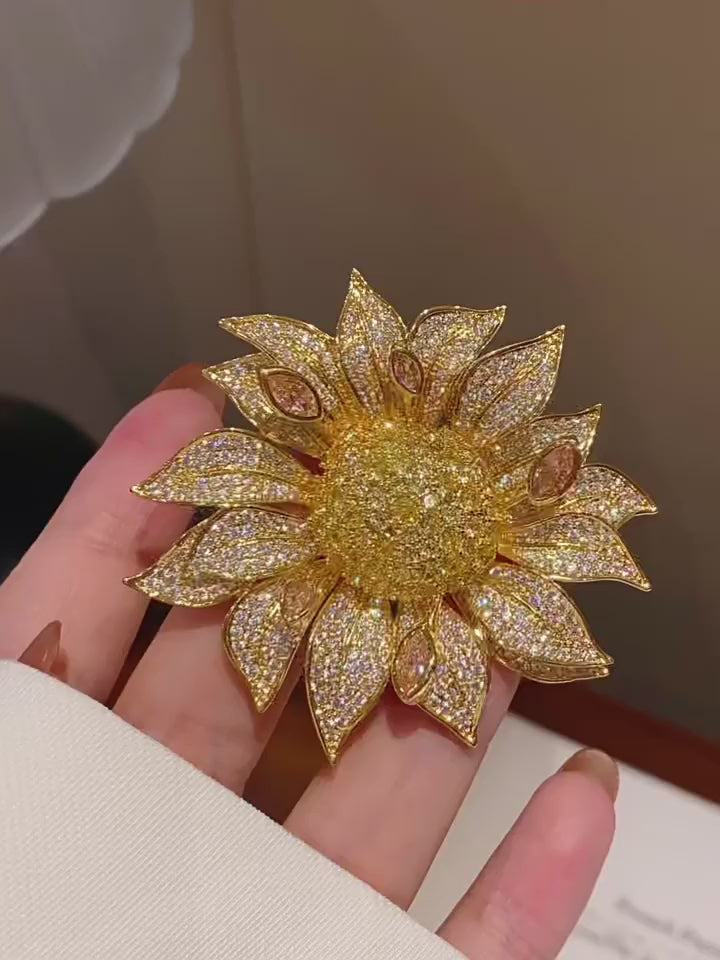 Solvi Layered Crystal Sunflower Brooch in Gold shown from multiple angles in motion
