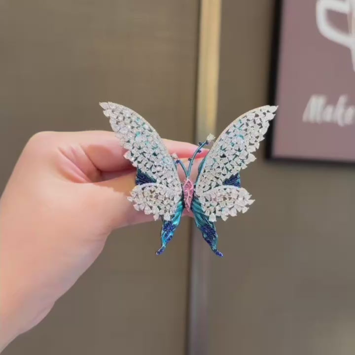 Tilda openwork blue butterfly brooch in motion; silent 8-second square close-up.