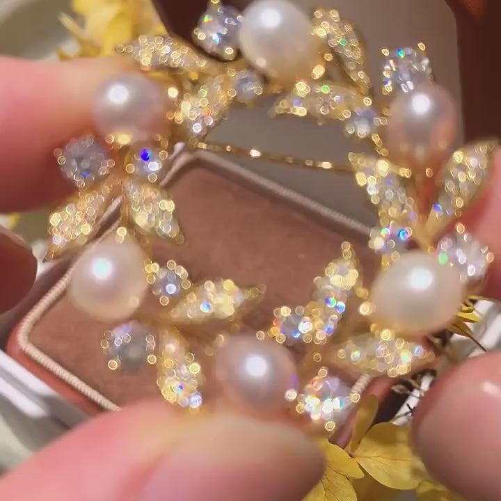Olea Freshwater Pearl Wreath Brooch turned by hand as its natural freshwater pearls, clear zircon accents and pin back move in a square close-up.
