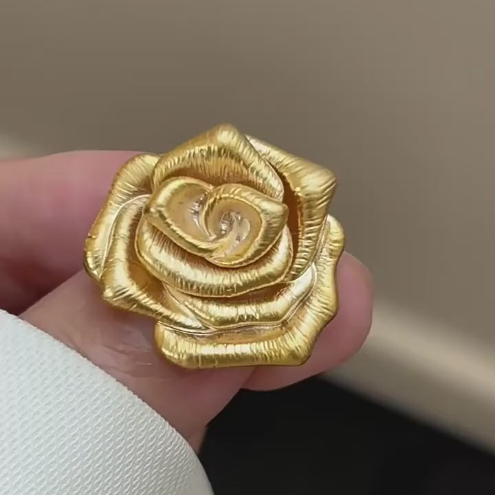 Taimi Mini Gold Camellia Brooch shown from the front, side, and back in motion