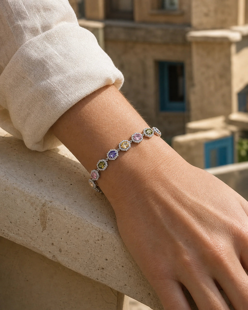 Close wrist view of the Prisma Multicolor Zircon Link Bracelet showing its oval color sequence and clear halos.