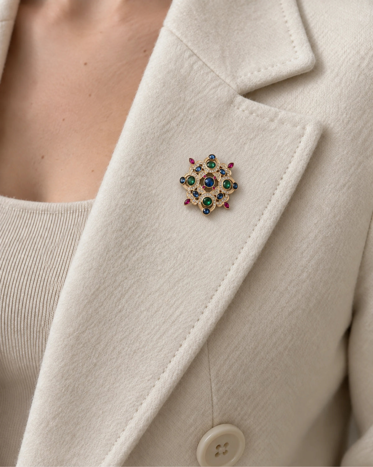 Ragna Multicolor Ornate Medallion Brooch — model wearing the brooch on a jacket lapel, close view