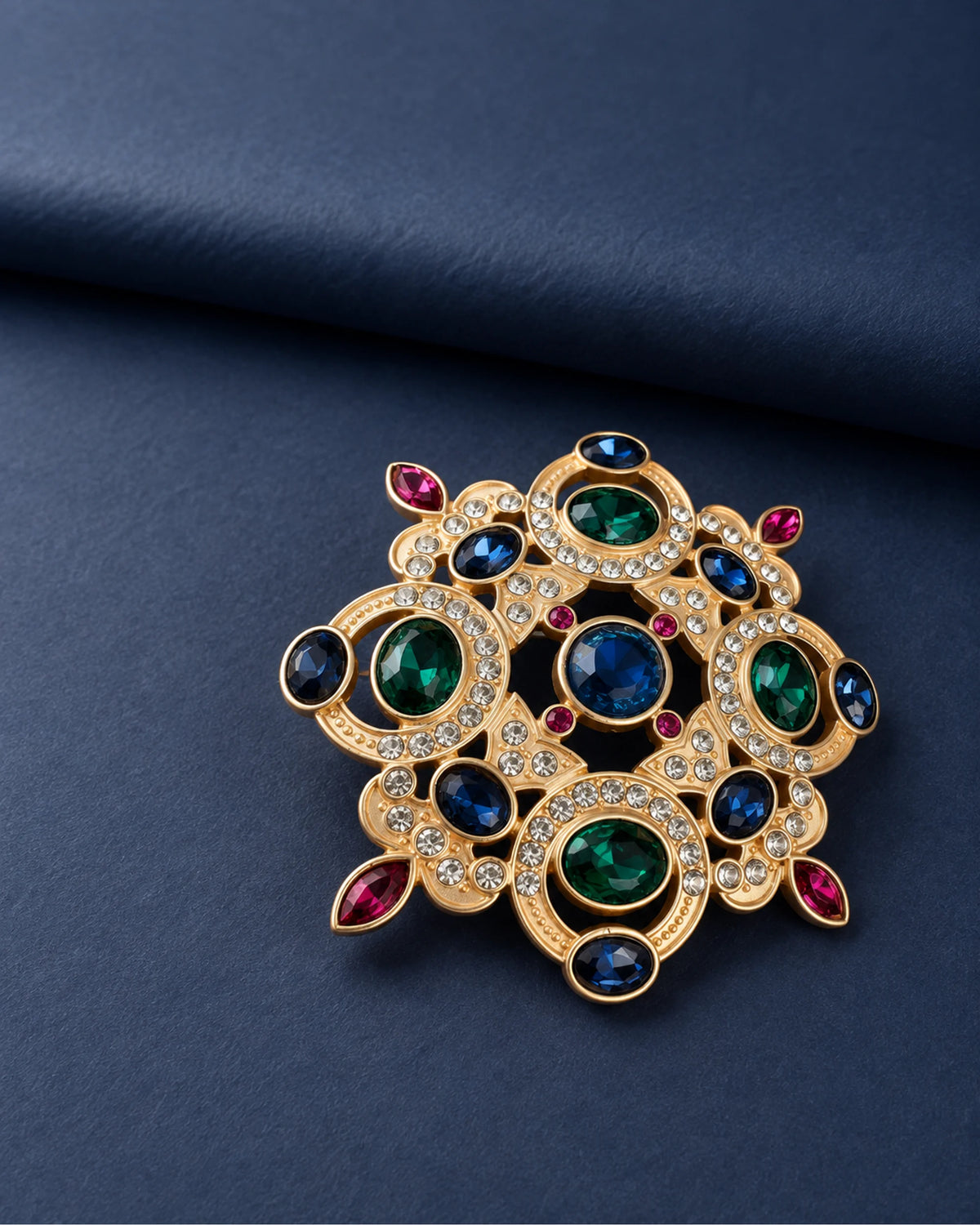 Ragna Multicolor Ornate Medallion Brooch — front display on folded slate-blue paper