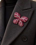 Raisa red butterfly brooch fully contained on a charcoal wool coat lapel