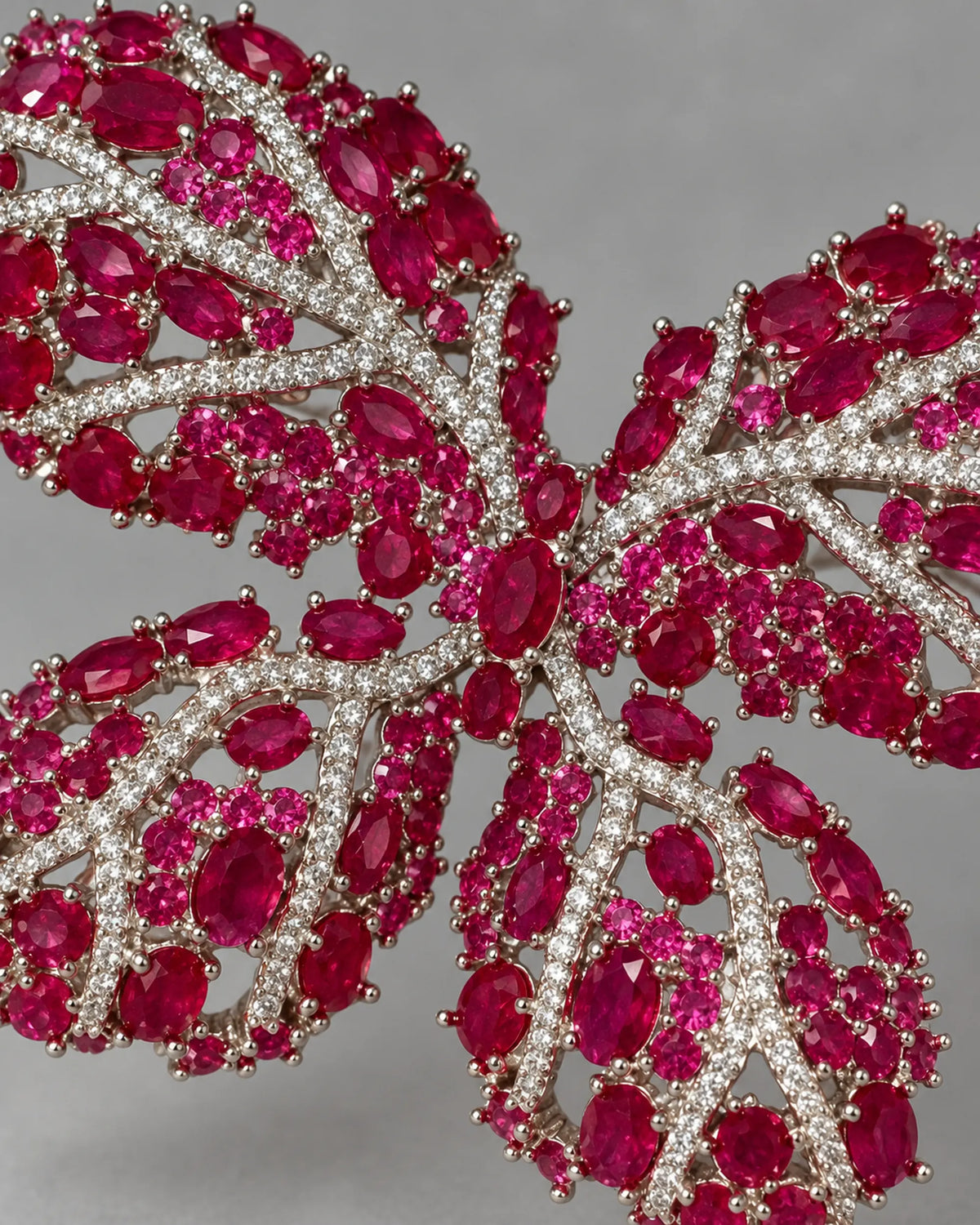 Close detail of Raisa synthetic red corundum stones, clear veins and silver-tone prongs