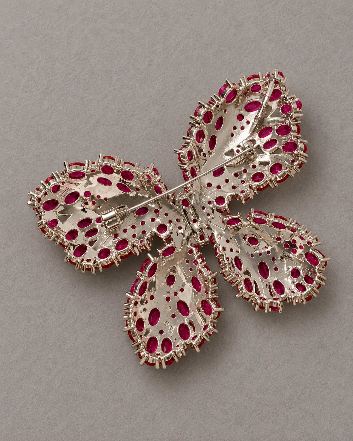 Reverse of Raisa butterfly brooch showing the actual hinged pin and open stone settings