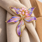Pink Violet Riina brooch secured to the supported fold of an oatmeal scarf.