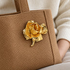 Rosana Sculpted Rose Brooch — on a sturdy bag