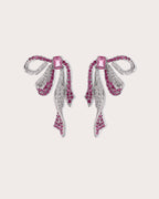 Runa Ribbon Bow Drop Earrings in White & Fuchsia on a soft blush background