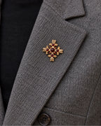 Rurik Red Lion Cross Brooch — model wearing the brooch on a jacket lapel, close view