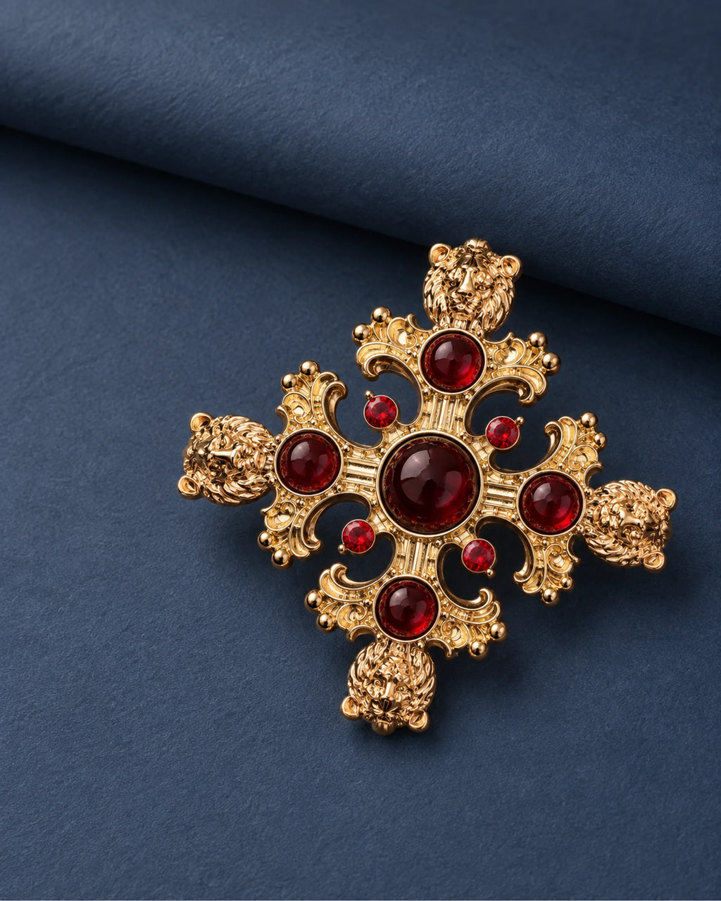Rurik Red Lion Cross Brooch — front display on folded slate-blue paper