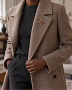 Rurik Red Lion Cross Brooch — model wearing the brooch with a tailored outfit, wider view