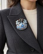 The Blue & White pumpkin sits inside a charcoal lapel above an ivory knit.