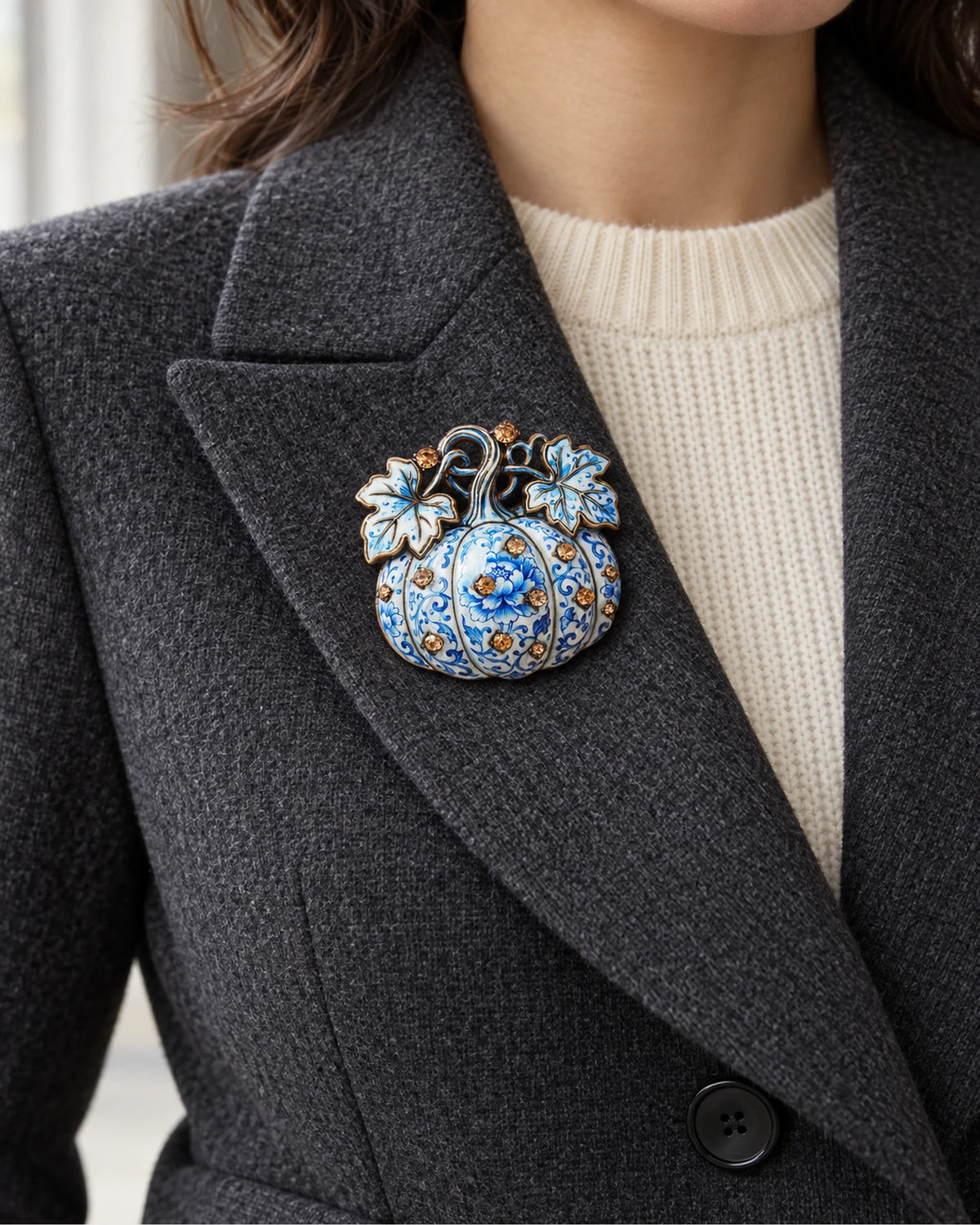 The Blue & White pumpkin sits inside a charcoal lapel above an ivory knit.