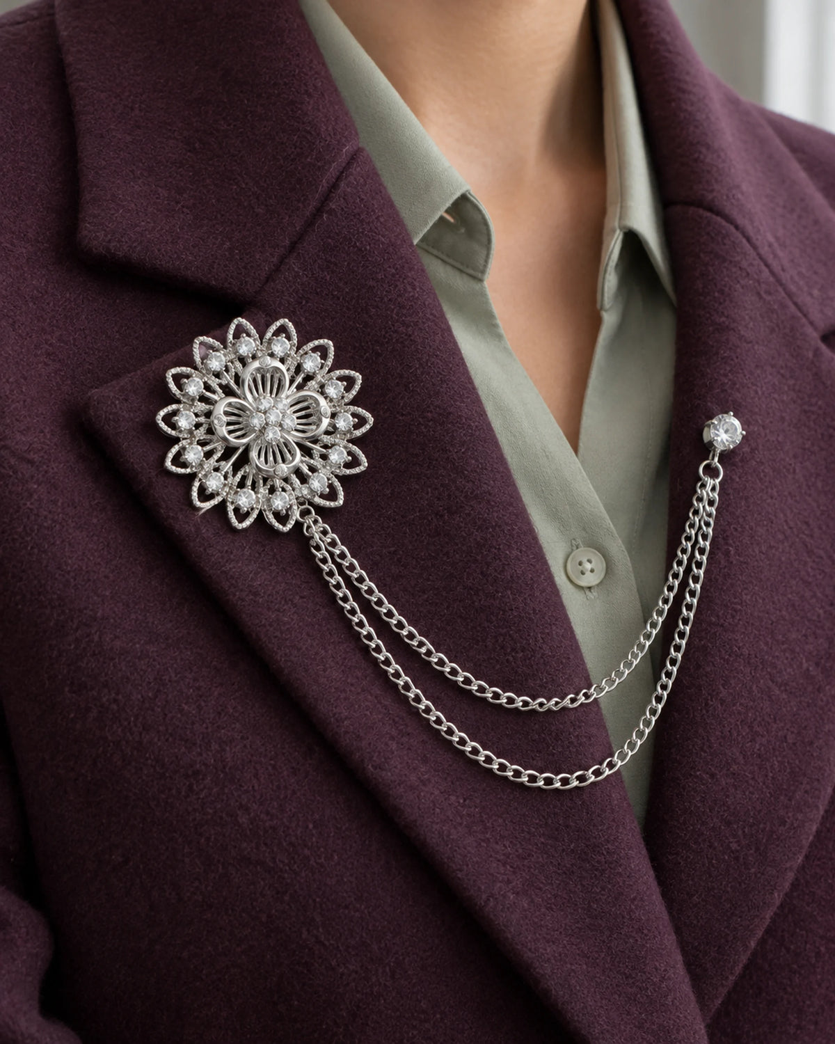 Ruusuke Filigree Flower Lapel Chain Brooch in silver-tone finish; close wearing view on a structured lapel