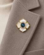 Saila Blue Shell Flower Magnetic Brooch, Gold & Midnight Blue worn on a taupe jacket lapel, close view