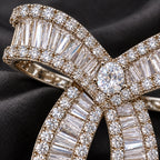 Baguette zircon rows meet round pavé borders around the oval centre.