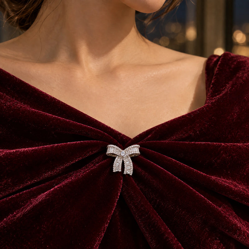 A reinforced velvet fold supports the small bow below the neckline.