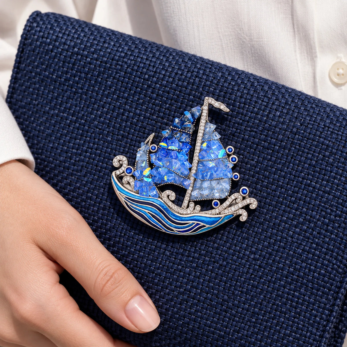 Seili Blue Sailboat Brooch — on a fabric bag