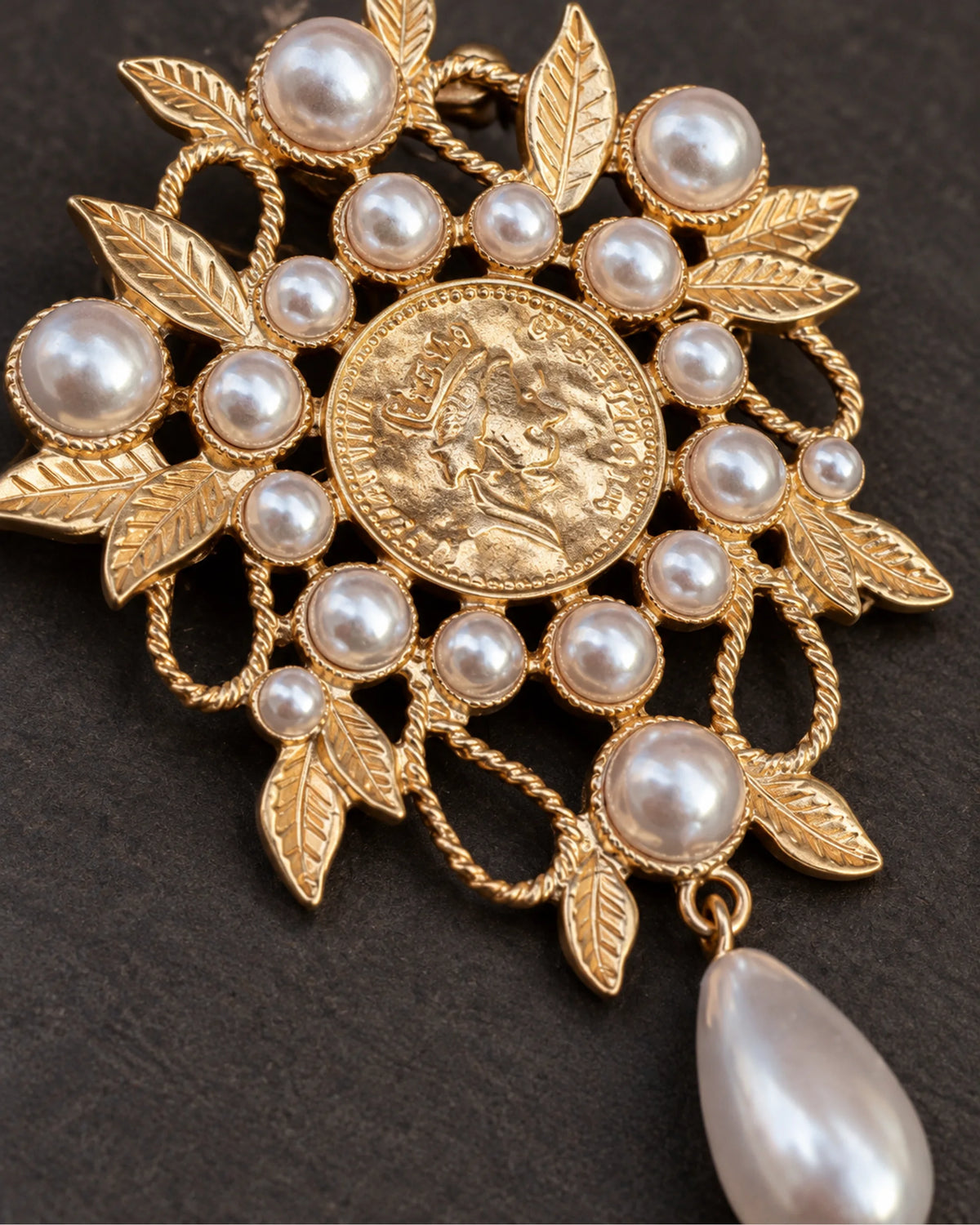 Signe Coin Medallion Drop Brooch — raised ornament and surface details, macro view