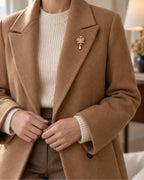 Signe Coin Medallion Drop Brooch — model wearing the brooch with a tailored outfit, wider view