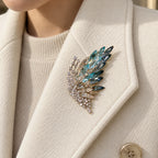 Siiri Marquise Fan Butterfly Brooch pinned completely inside one broad ivory wool lapel.