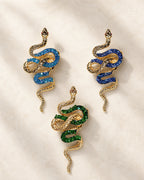 Three Sisu snake brooch variants in lake blue, royal blue and green shown together at equal scale