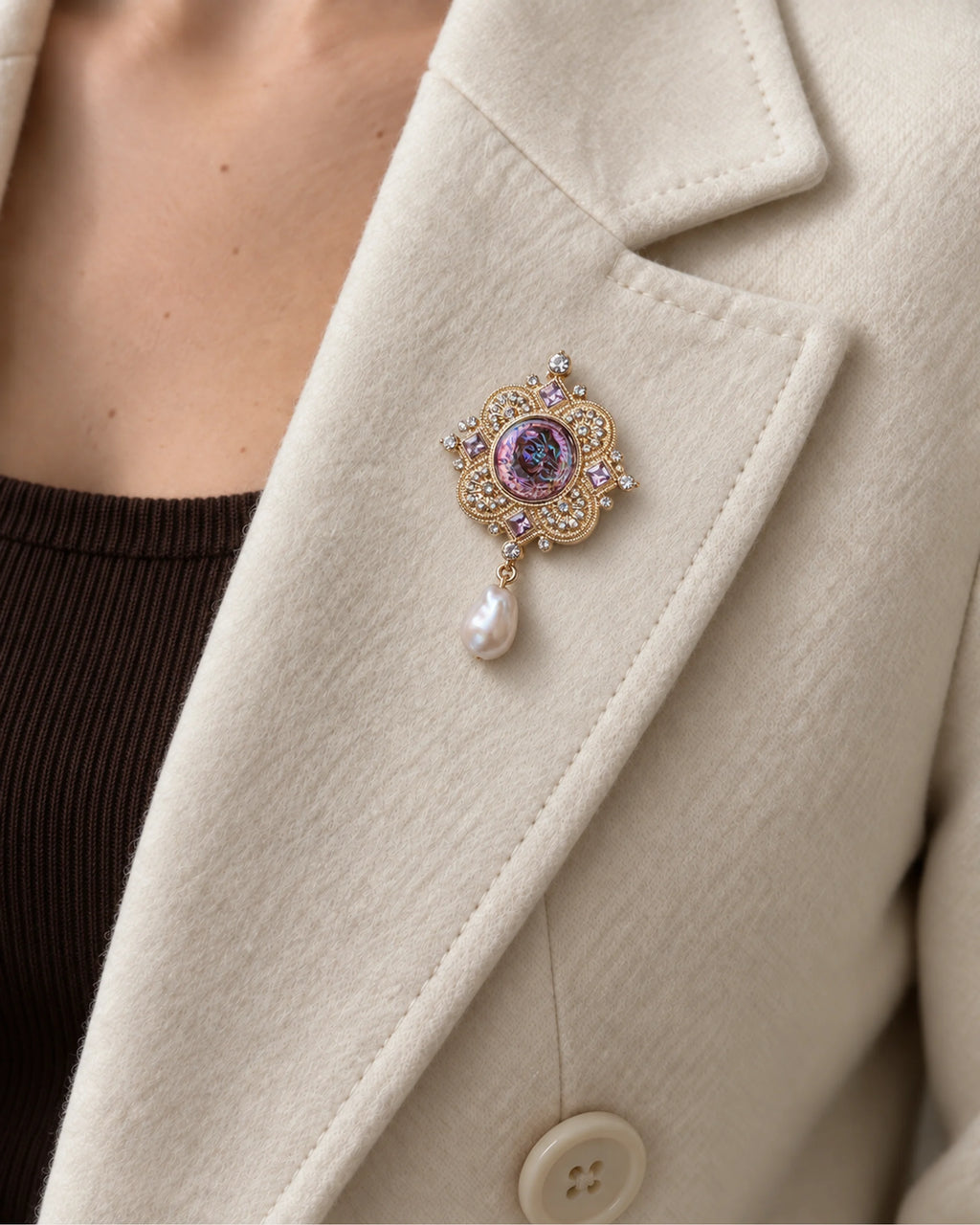 Siv Purple Face Medallion Brooch — model wearing the brooch on a jacket lapel, close view