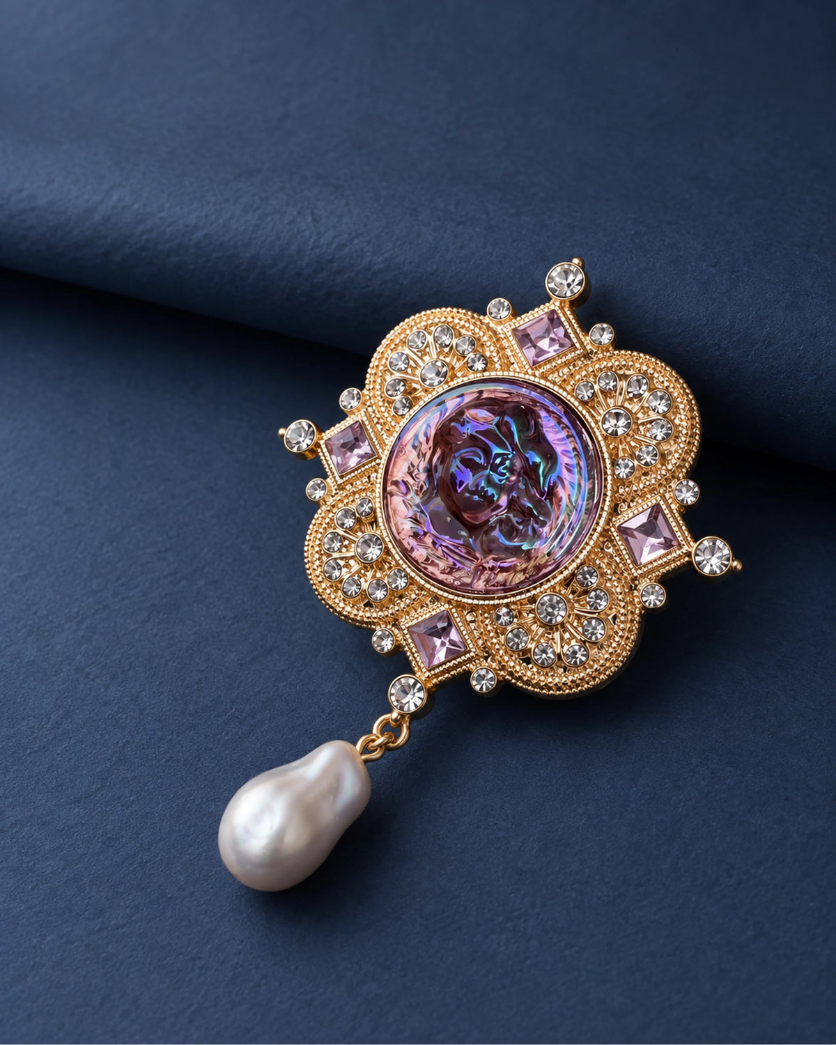 Siv Purple Face Medallion Brooch — front display on folded slate-blue paper