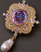 Siv Purple Face Medallion Brooch — raised ornament and surface details, macro view