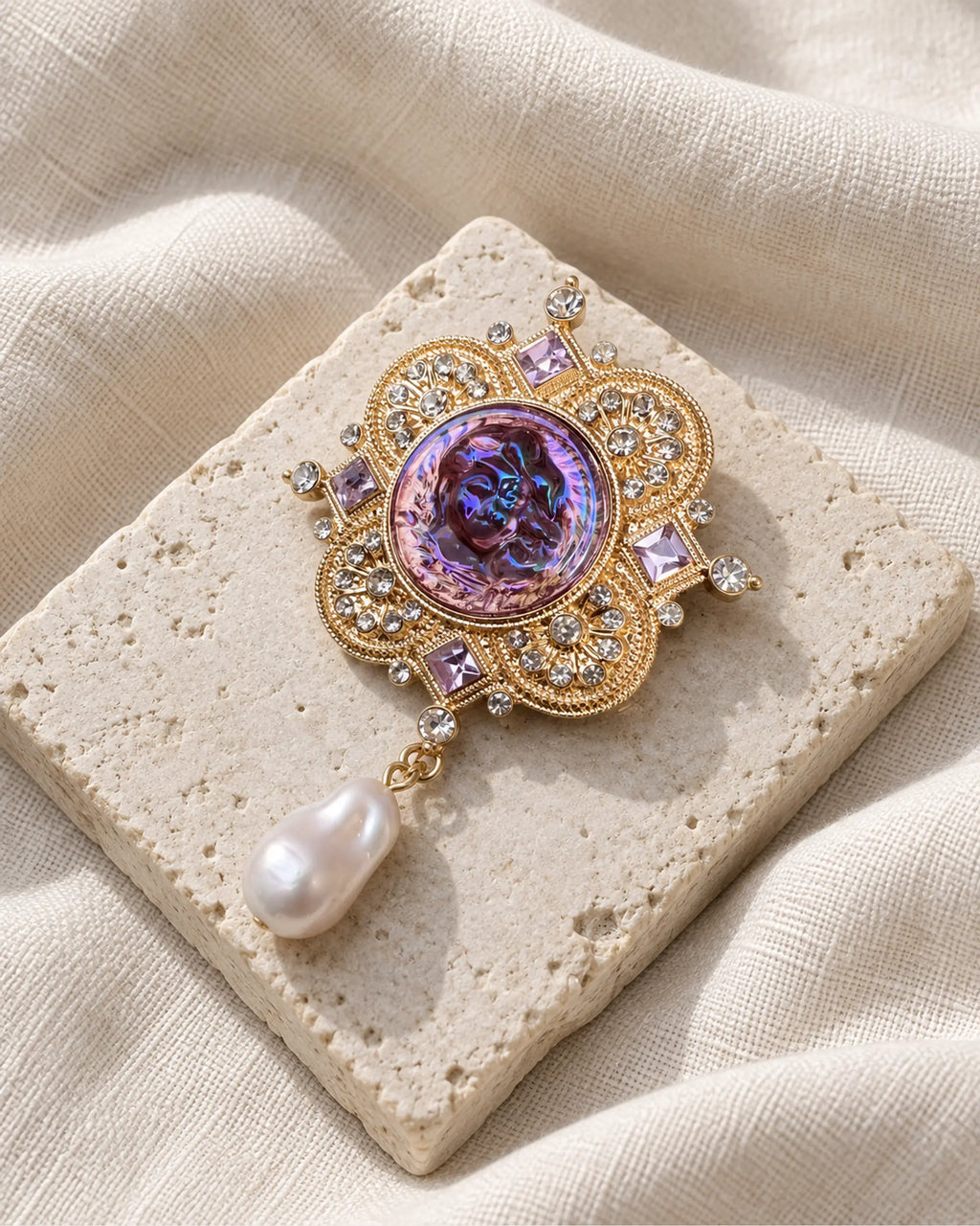 Siv Purple Face Medallion Brooch — front view on a stone tile and ivory linen