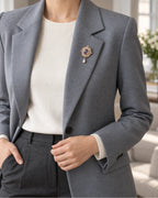 Siv Purple Face Medallion Brooch — model wearing the brooch with a tailored outfit, wider view