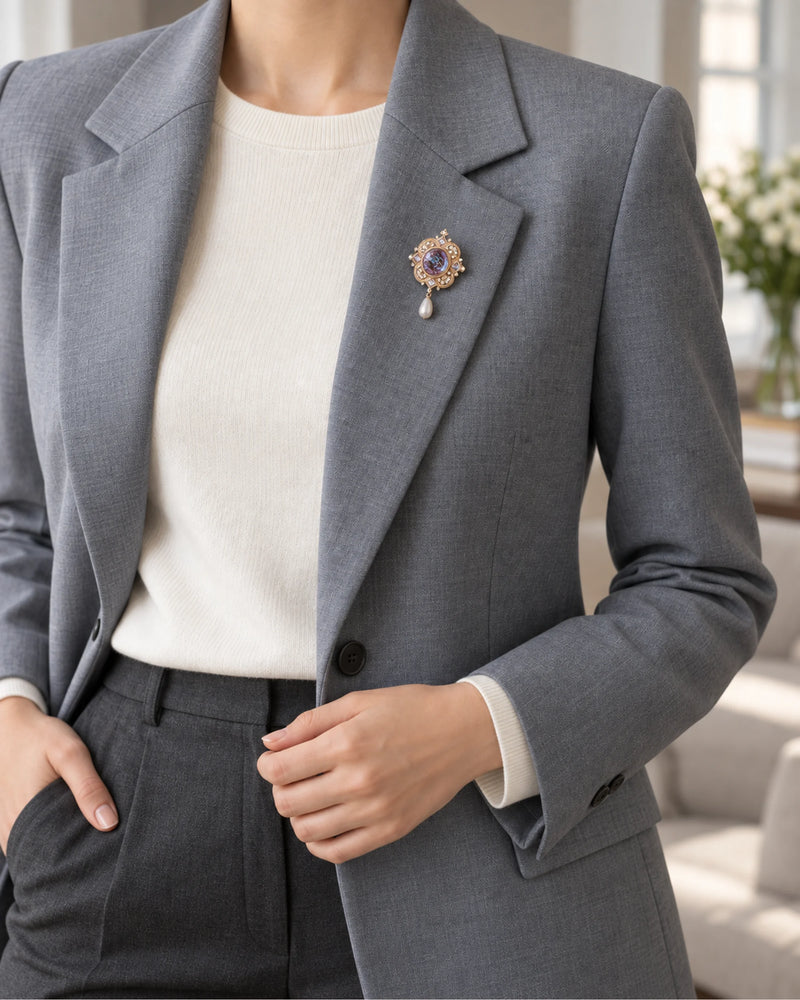 Siv Purple Face Medallion Brooch — model wearing the brooch with a tailored outfit, wider view