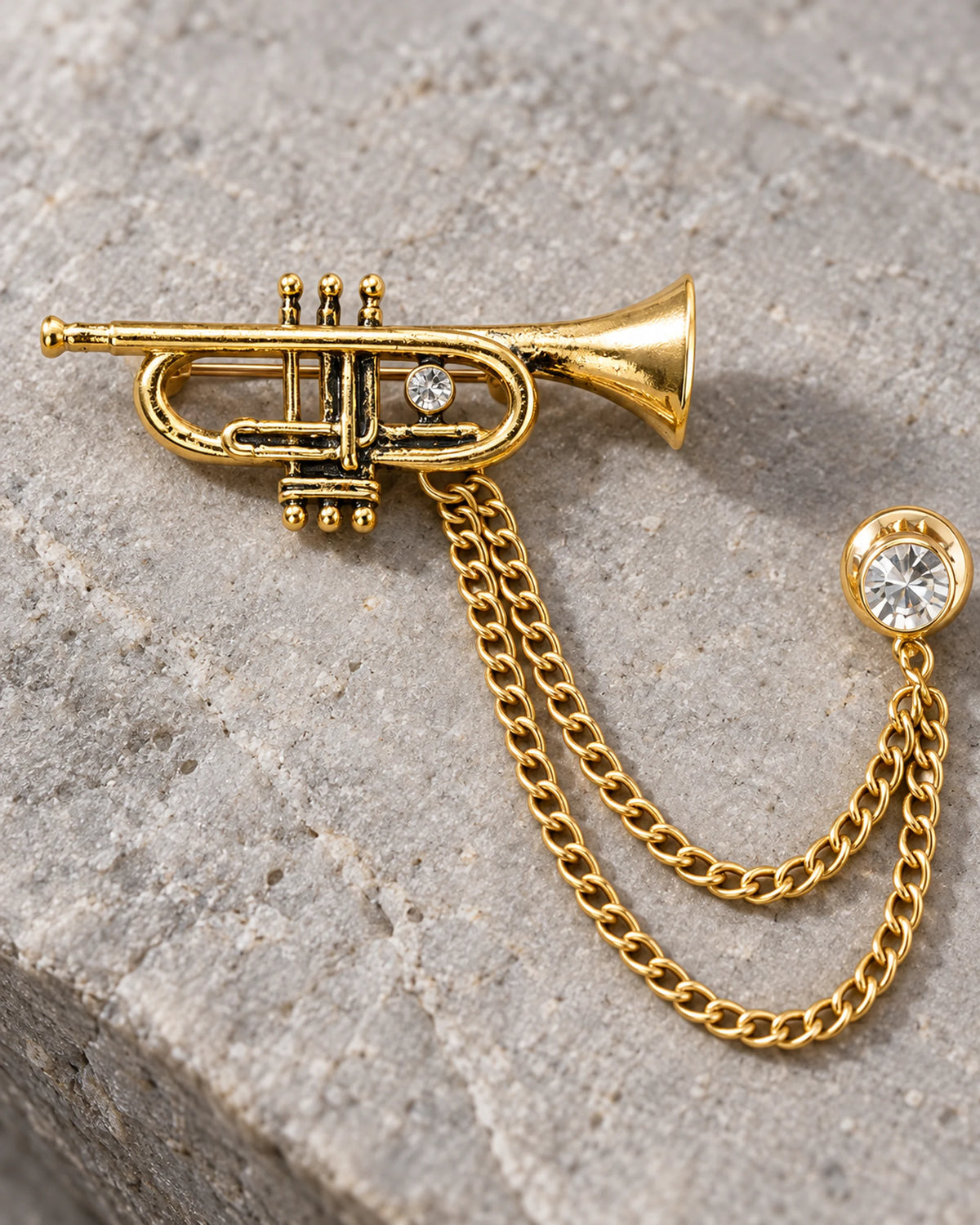 Sointu Trumpet Lapel Chain Brooch in gold-tone finish; motif and chain detail