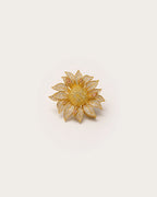 Solvi Layered Crystal Sunflower Brooch on a warm #F0EBE9 studio background with a natural contact shadow