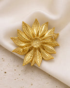 Back of the Solvi Sunflower Brooch showing its long pin stem, hinge and clasp on ivory silk