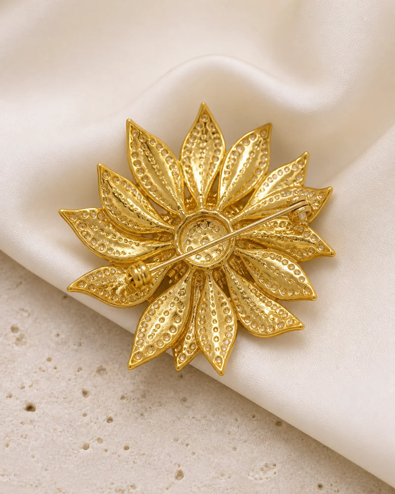 Back of the Solvi Sunflower Brooch showing its long pin stem, hinge and clasp on ivory silk