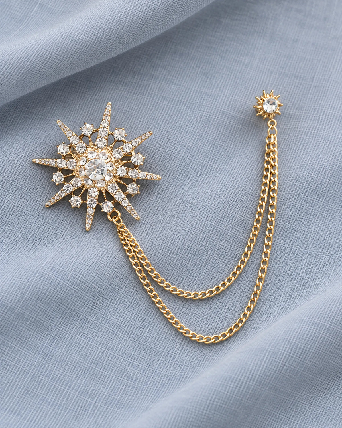 Stella Starburst Lapel Chain Brooch in gold-tone finish — product still life