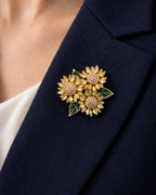 Suvia yellow crystal sunflower brooch with raised gold-tone centers pinned inside a navy lapel