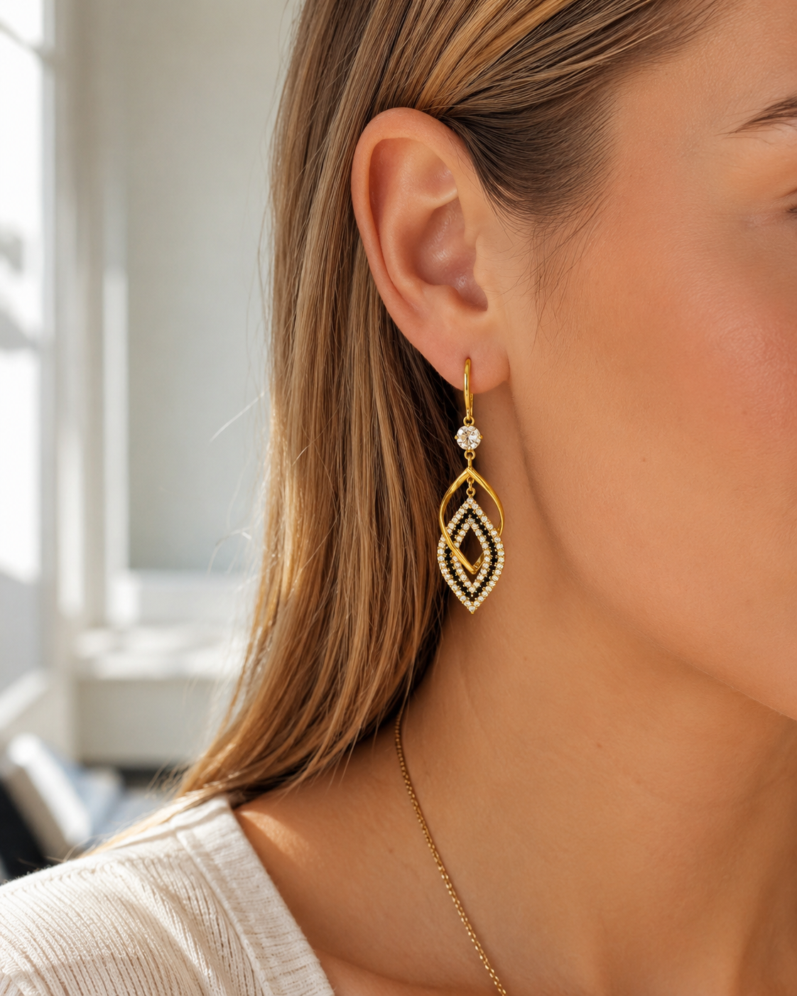 Tahti Crystal Drop Earrings with clear crystal accents and warm gold tone