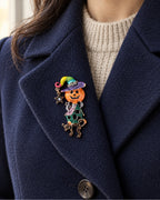 The complete witch, star and cat fit inside a broad navy lapel over an oatmeal knit.