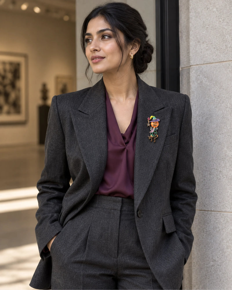 Taika's narrow silhouette adds a small vertical accent to charcoal tailoring and a plum blouse.