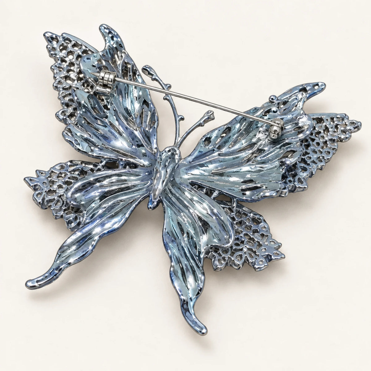 Rear view of Tilda butterfly brooch showing sculpted metal wing backs and the pin fastening.