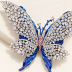 Close detail of the pink centre, open clear-stone lattice and blue sculpted wings.