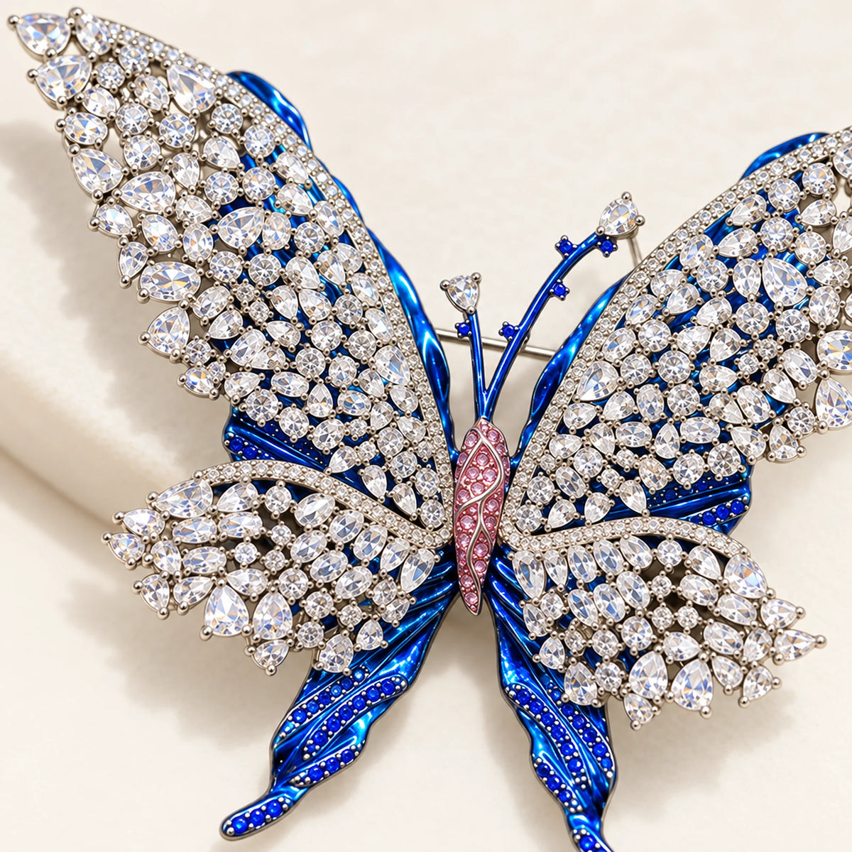 Close detail of the pink centre, open clear-stone lattice and blue sculpted wings.