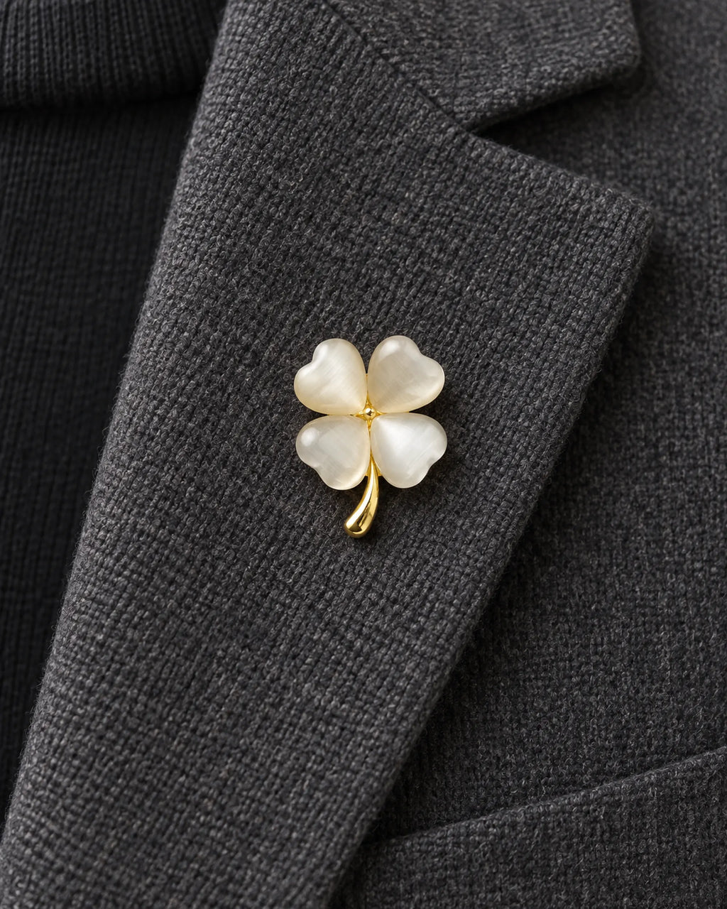 Tova Cat-Eye Clover Magnetic Brooch, Gold & White worn on a charcoal jacket lapel, close view