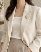 Tova Cat-Eye Clover Magnetic Brooch, Gold & White worn with a cream jacket, wider styling view